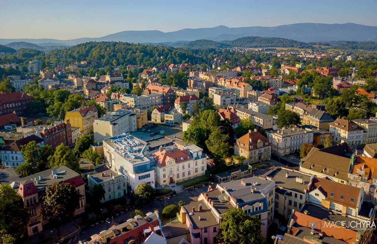 Aerial view of the European town and mountain setting around KCM Longevity Clinic